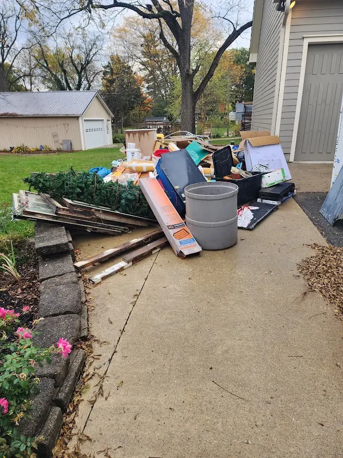 Dumpster being loaded with debris for 12 Yard Dumpster Rental in New Berlin